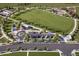 Aerial view of park featuring an expansive green space, playground, parking area, and walking paths at 6570 Parterre N Pkwy # 2, Thornton, CO 80602