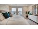 This bedroom boasts bright windows, neutral gray carpet, and modern decor at 6570 Parterre N Pkwy # 2, Thornton, CO 80602