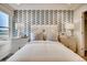Well lit bedroom featuring modern white furniture and window view at 6570 Parterre N Pkwy # 2, Thornton, CO 80602