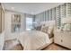 Stylish bedroom with window view and modern blue accent wall at 6570 Parterre N Pkwy # 2, Thornton, CO 80602
