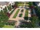 Aerial view of a bocce ball court surrounded by lush landscaping and walking paths in a vibrant community setting at 6570 Parterre N Pkwy # 2, Thornton, CO 80602