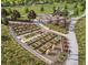 Aerial view of a community garden showcasing raised garden beds, a playground, and walking paths in the community at 6570 Parterre N Pkwy # 2, Thornton, CO 80602