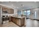 Modern kitchen features stainless steel appliances, granite counters, and wood-look floors at 6570 Parterre N Pkwy # 2, Thornton, CO 80602