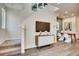 Living area with stairs, view to the dining area, and a modern cabinet at 6570 Parterre N Pkwy # 2, Thornton, CO 80602
