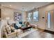 Bright living room with large windows and contemporary furnishings at 6570 Parterre N Pkwy # 2, Thornton, CO 80602