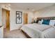 Main bedroom features accent wall, carpeted floors, and an en-suite bathroom at 6570 Parterre N Pkwy # 2, Thornton, CO 80602