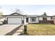 Charming single-Gathering home featuring a manicured front lawn, attached garage, and brick accents at 558 S Field Ct, Lakewood, CO 80226