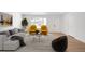Bright living room featuring hardwood floors, natural light, and stylish contemporary furniture at 558 S Field Ct, Lakewood, CO 80226
