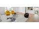 Bright living room featuring hardwood floors, natural light, and stylish contemporary furniture at 558 S Field Ct, Lakewood, CO 80226
