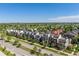Scenic aerial view showcasing modern townhomes nestled among lush trees and a well-manicured street at 9158 Martin Luther King Blvd, Denver, CO 80238