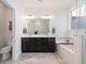 Luxurious bathroom featuring a double sink vanity, soaking tub, and modern fixtures at 9158 Martin Luther King Blvd, Denver, CO 80238