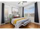 Cozy bedroom features bright windows, shutters, hardwood floors, and unique decor at 9158 Martin Luther King Blvd, Denver, CO 80238