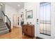 Inviting entryway featuring hardwood floors, a charming console table, and a decorative mirror at 9158 Martin Luther King Blvd, Denver, CO 80238