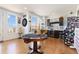 Spacious game room with hardwood floors, natural light, and custom bar area at 9158 Martin Luther King Blvd, Denver, CO 80238
