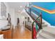 Bright hallway with hardwood floors, staircase, and a colorful accent wall at 9158 Martin Luther King Blvd, Denver, CO 80238