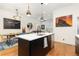 Open kitchen design with seating, a stylish faucet, and stainless appliances at 9158 Martin Luther King Blvd, Denver, CO 80238