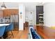 Bright, open kitchen with stainless steel appliances, wood cabinets, and stylish breakfast bar seating at 9158 Martin Luther King Blvd, Denver, CO 80238