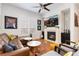 Stylish living room boasts a modern fireplace, hardwood floors, and large TV at 9158 Martin Luther King Blvd, Denver, CO 80238