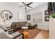 Beautiful living area featuring a leather couch, modern decor, and hardwood flooring at 9158 Martin Luther King Blvd, Denver, CO 80238