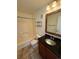 Bathroom featuring tiled floors, dark vanity, and a shower-tub combo at 3025 Broadway St # 17, Boulder, CO 80304