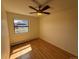 Bright bedroom with hardwood floors, ceiling fan, and mountain views from the window at 3025 Broadway St # 17, Boulder, CO 80304
