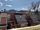 Exterior view of a brown townhouse featuring multiple stories, decks, and scenic mountain views at 3025 Broadway St # 17, Boulder, CO 80304