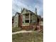 Two-story green home featuring a porch, round window, and multiple chimneys at 3025 Broadway St # 17, Boulder, CO 80304