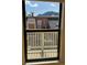 View from a window showing a neighboring townhouse with decks and scenic mountains in the background at 3025 Broadway St # 17, Boulder, CO 80304