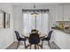 Charming dining area with modern light fixture and views of the manicured backyard at 5207 Dudley St, Arvada, CO 80002