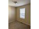 Vacant bedroom with carpet, tan walls, and a window at 10158 Granby St, Commerce City, CO 80022