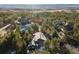 Overhead view of a home in a lush, green neighborhood, with mountains in the distance at 108 Castle Pines N Dr, Castle Rock, CO 80108
