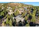 Panoramic view showcasing the neighborhood homes nestled amongst the trees on a hillside at 108 Castle Pines N Dr, Castle Rock, CO 80108