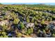Aerial view of a luxury home surrounded by lush greenery and mature trees at 108 Castle Pines N Dr, Castle Rock, CO 80108