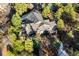 Scenic aerial view highlighting the home's roof, decks, and surrounding trees at 108 Castle Pines N Dr, Castle Rock, CO 80108