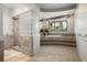 Luxurious bathroom features a glass-block wall shower and raised soaking tub, creating a spa-like retreat at 108 Castle Pines N Dr, Castle Rock, CO 80108