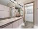 Bright bathroom featuring a large vanity, ample storage, and a well-organized walk-in closet at 108 Castle Pines N Dr, Castle Rock, CO 80108