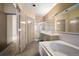 Bathroom with double vanity, separate shower, and large soaking tub, offering a spa-like experience at 108 Castle Pines N Dr, Castle Rock, CO 80108