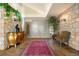 Elegant entryway with stone walls and ornate furniture at 108 Castle Pines N Dr, Castle Rock, CO 80108