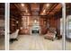 Sophisticated home office with custom wood bookshelves, fireplace, and comfortable seating at 108 Castle Pines N Dr, Castle Rock, CO 80108