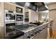Gourmet kitchen with stainless steel appliances including an oven and cooktop at 108 Castle Pines N Dr, Castle Rock, CO 80108