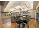 Spacious kitchen featuring an island with bar seating, wood floors, and modern appliances at 108 Castle Pines N Dr, Castle Rock, CO 80108