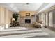 Spacious living room with a stone fireplace, creating a cozy and inviting gathering space at 108 Castle Pines N Dr, Castle Rock, CO 80108