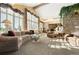 Inviting living room with vaulted ceilings, stone fireplace, and large windows offering scenic views at 108 Castle Pines N Dr, Castle Rock, CO 80108