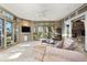 Bright living room with fireplace and access to an outdoor balcony and beautiful vistas at 108 Castle Pines N Dr, Castle Rock, CO 80108