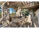 Covered outdoor patio features a dining table and seating, perfect for entertaining guests at 108 Castle Pines N Dr, Castle Rock, CO 80108