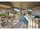 Covered patio with stone pillars and hot tub provides a relaxing outdoor space at 108 Castle Pines N Dr, Castle Rock, CO 80108