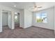 Bright bedroom with neutral carpet, large window, and an open layout at 5798 Biscay St, Denver, CO 80249