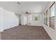 Bright living room with large windows, neutral carpet, and an open layout at 5798 Biscay St, Denver, CO 80249