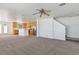 Open-concept living room leading to the kitchen with stainless steel appliances and an island at 5798 Biscay St, Denver, CO 80249