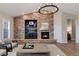 Spacious living room featuring a stone fireplace and hearth, built-in shelves, and chandelier at 10817 Greycliffe Dr, Highlands Ranch, CO 80126